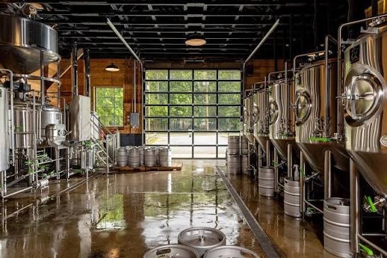 Craft brewery interior with fermentation tanks