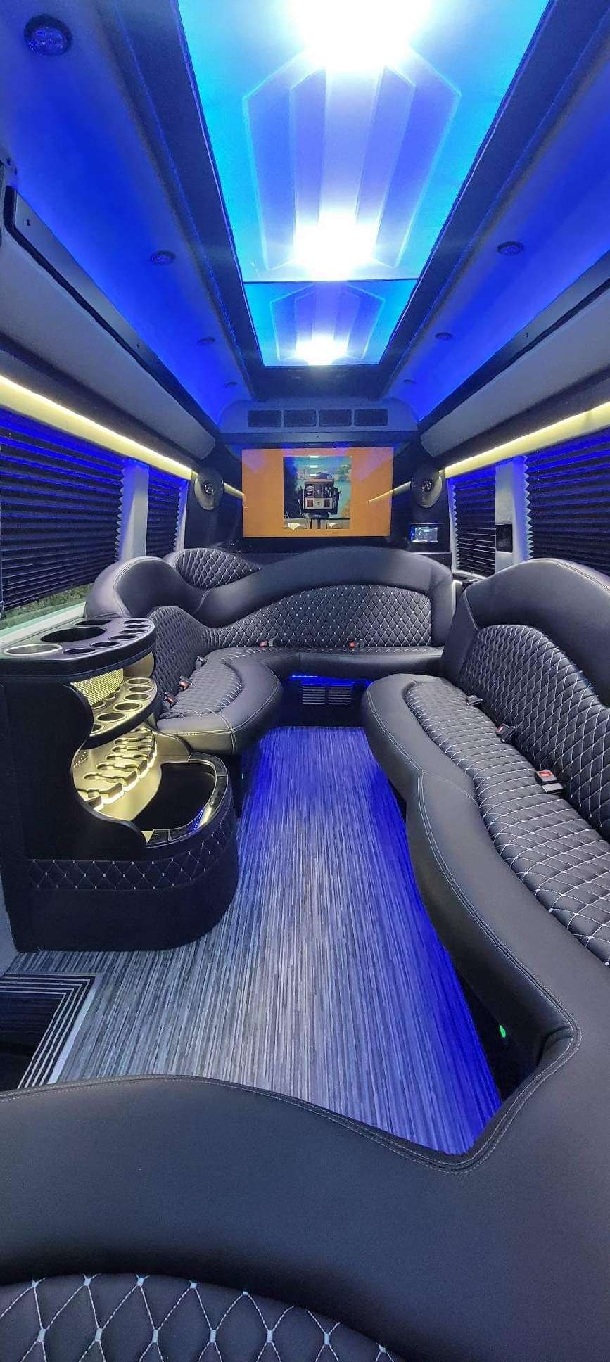 Party bus interior with purple neon lighting and premium seating